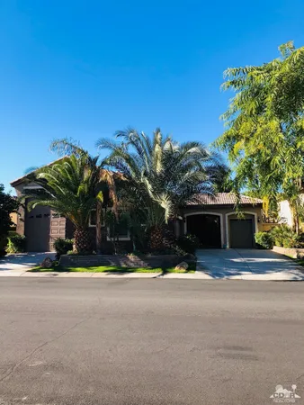 a view of house with outdoor space and palm tree