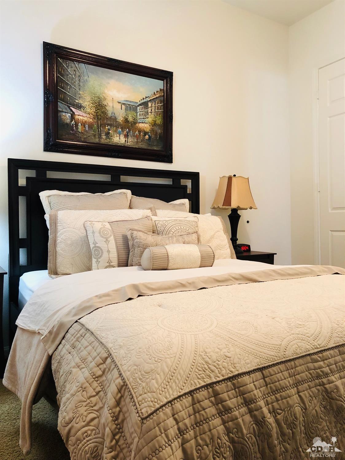 49535 Redford Way Indio, CA 92201 - Photo 14 of 28 a bedroom with a bed and painting on the wall