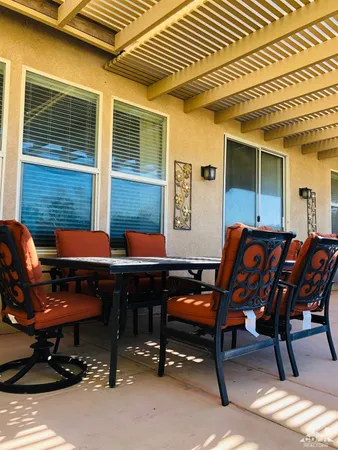 a backyard of a house with outdoor seating