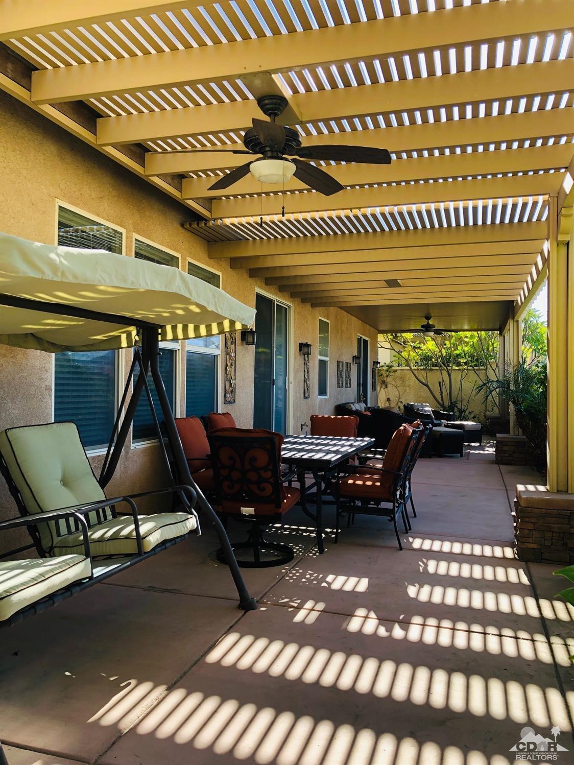 49535 Redford Way Indio, CA 92201 - Photo 18 of 28 a living room with a couch wooden floor and a fireplace