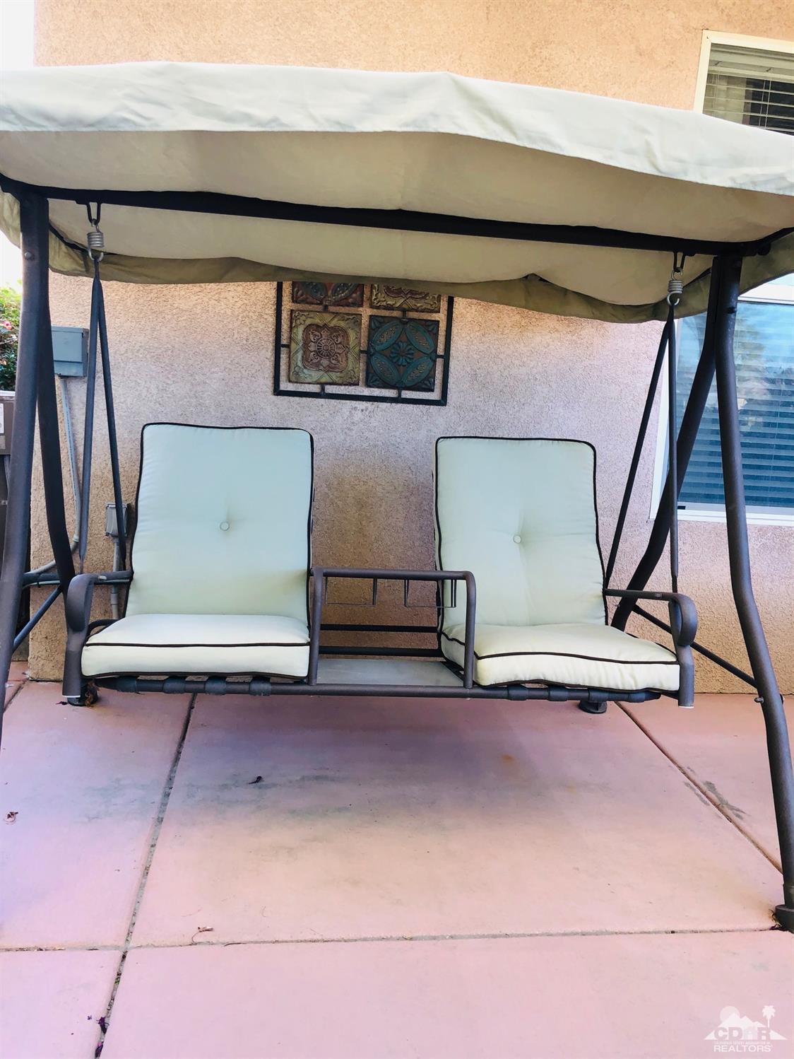49535 Redford Way Indio, CA 92201 - Photo 19 of 28 a front view of a house with garage