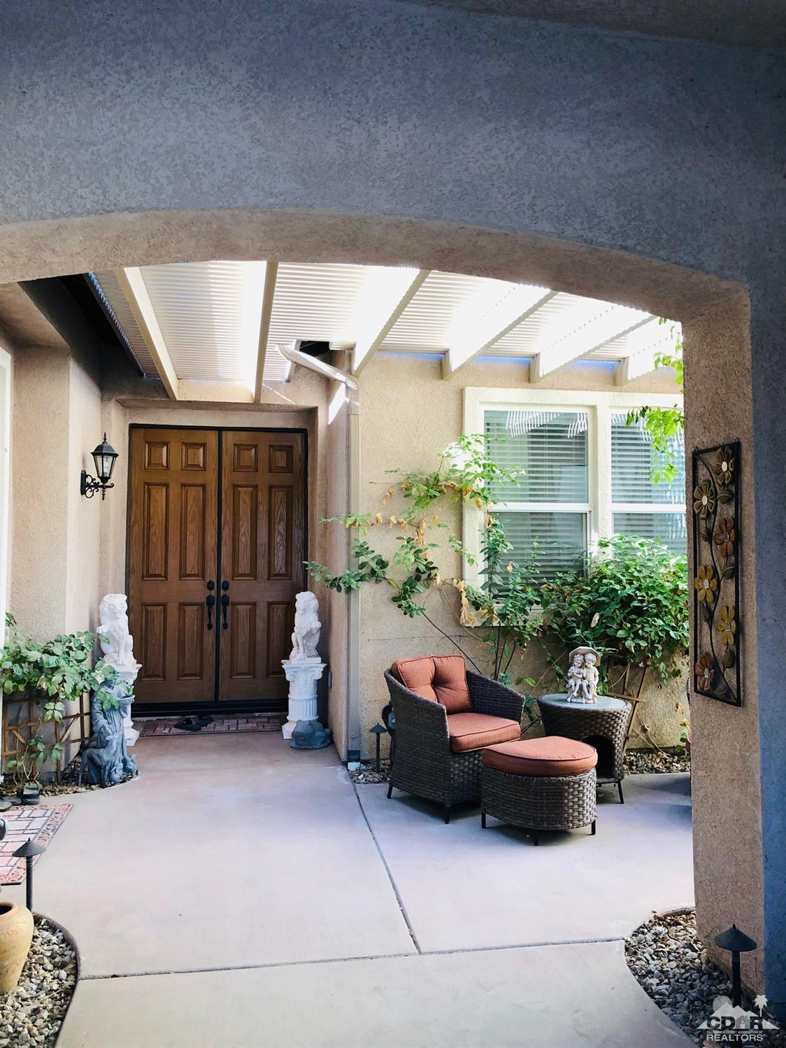 49535 Redford Way Indio, CA 92201 - Photo 4 of 28 a outdoor space with lots of potted plants and a couch