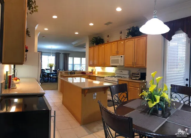 a kitchen with kitchen island granite countertop wooden cabinets and a granite counter tops