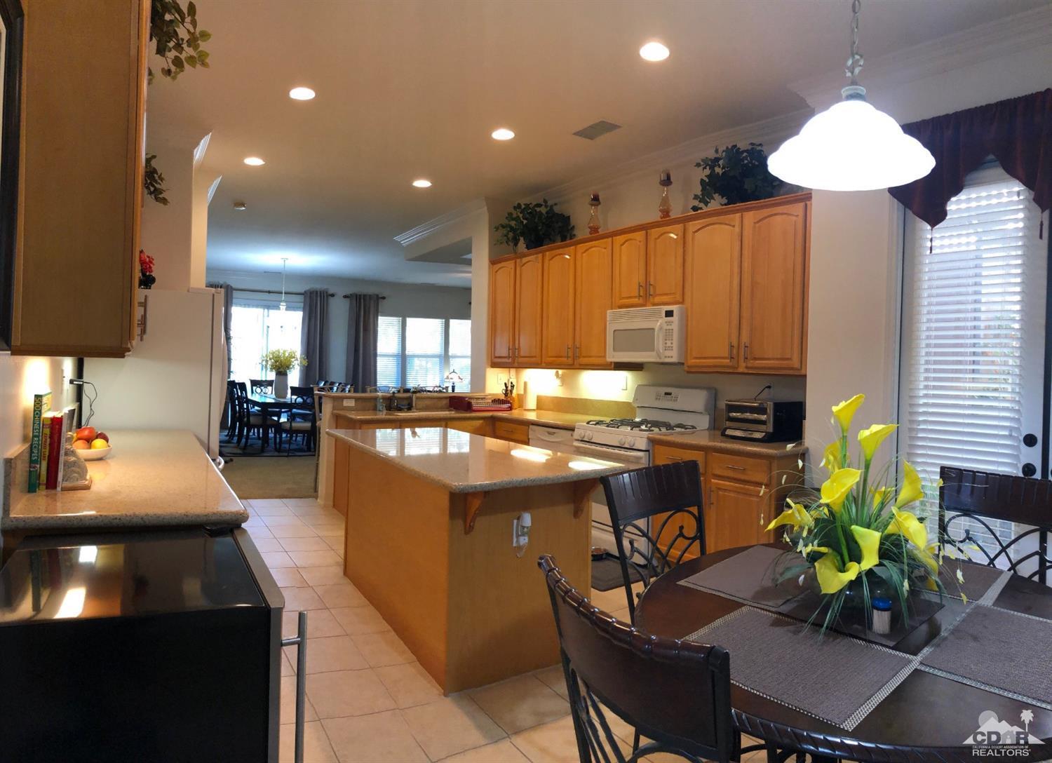 49535 Redford Way Indio, CA 92201 - Photo 6 of 28 a kitchen with kitchen island granite countertop lots of counter top space and cabinets