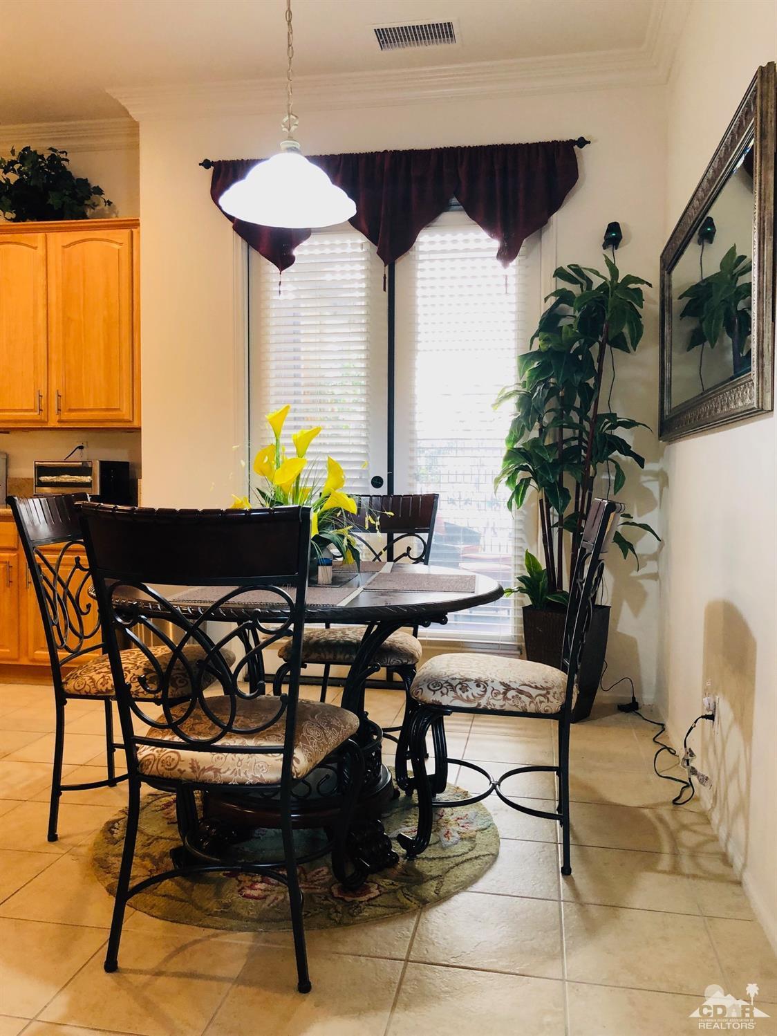 49535 Redford Way Indio, CA 92201 - Photo 7 of 28 a view of a dining room with furniture and a potted plant