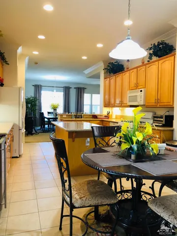 a kitchen with a table chairs and a dining table