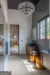 a kitchen with stainless steel appliances a dining table and chairs in it