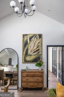a living room with furniture and a chandelier