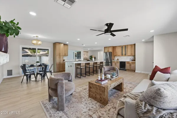 a living room with furniture kitchen view and a dining table