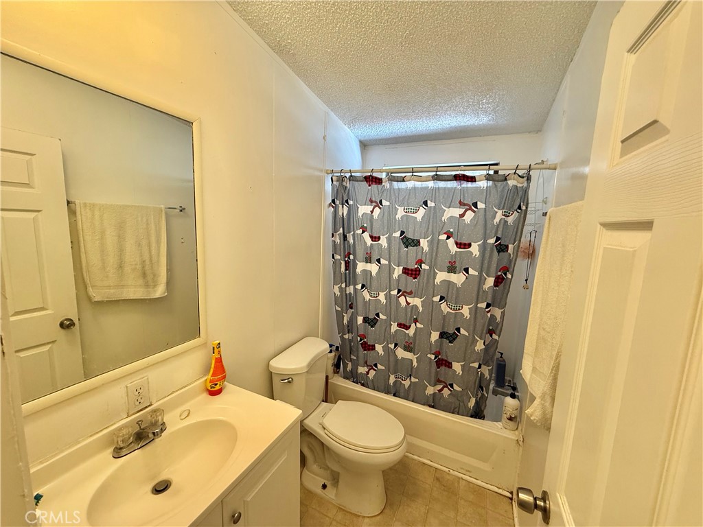 22020 Nisqually Road, Unit 65 Apple Valley, CA 92308 - Photo 8 of 14 a bathroom with a sink toilet and shower