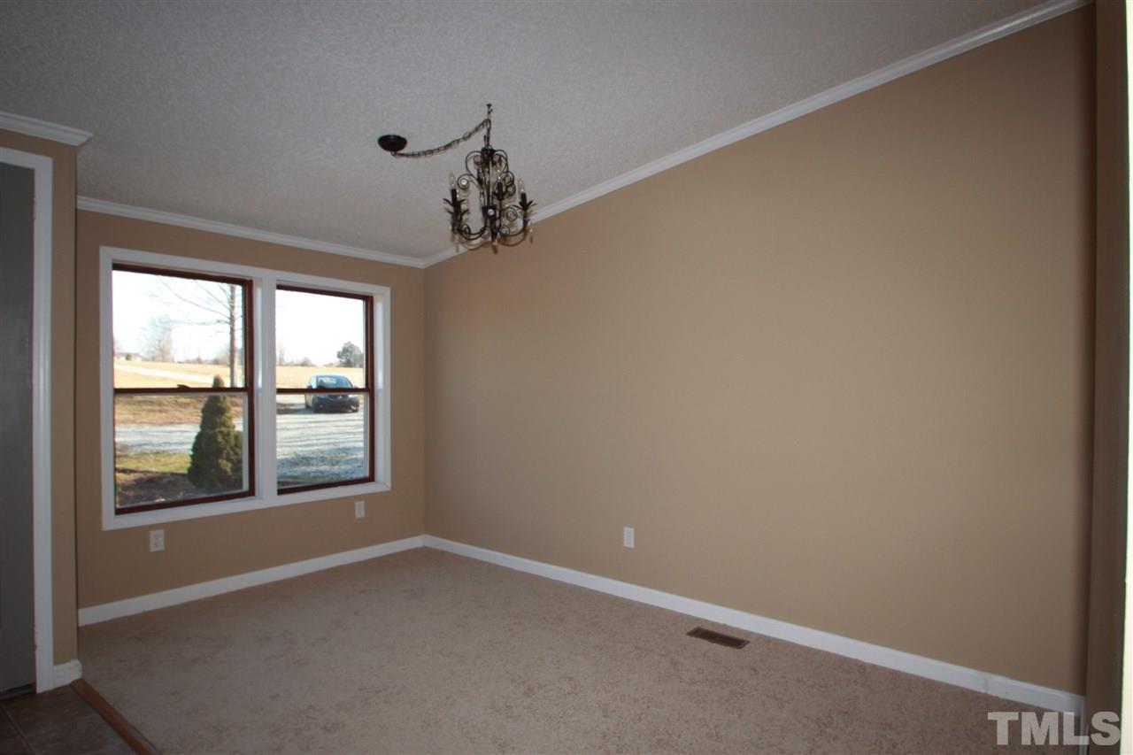290 Hal Melton Road Roxboro, NC 27574 - Photo 2 of 14 an empty room with a window