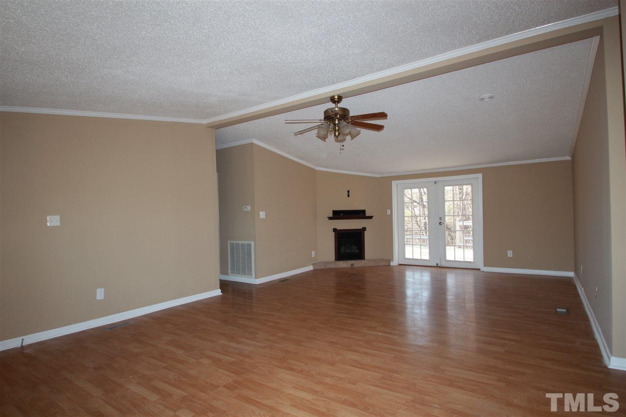 290 Hal Melton Road Roxboro, NC 27574 - Photo 5 of 14 a view of an empty room with a window and wooden floor