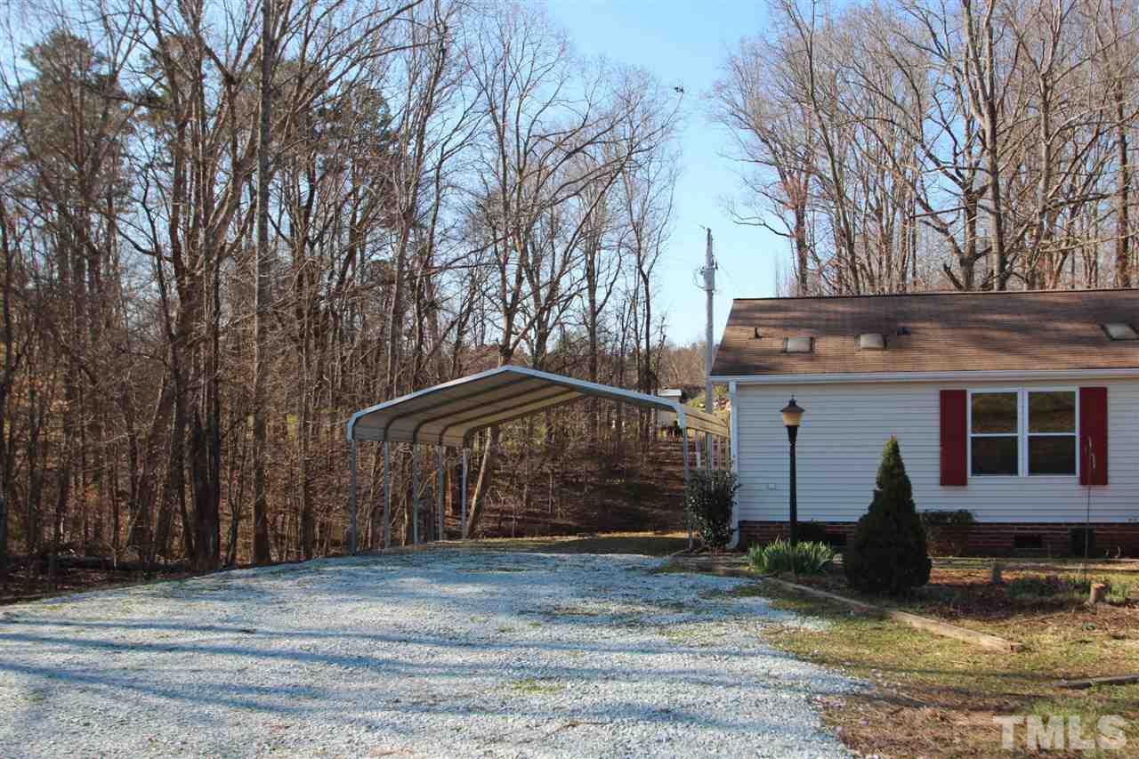 290 Hal Melton Road Roxboro, NC 27574 - Photo 6 of 14 a front view of a house with garden