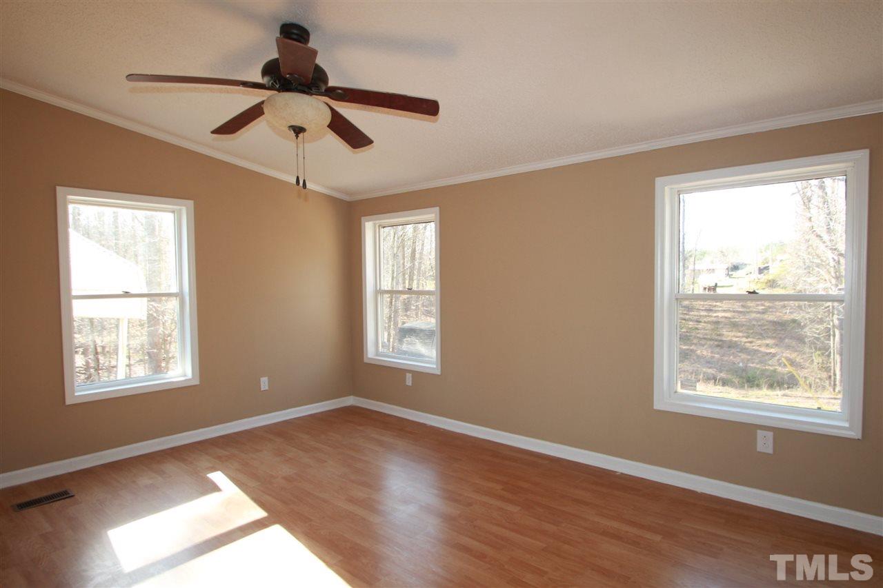 290 Hal Melton Road Roxboro, NC 27574 - Photo 7 of 14 a view of an empty room with wooden floor and a window