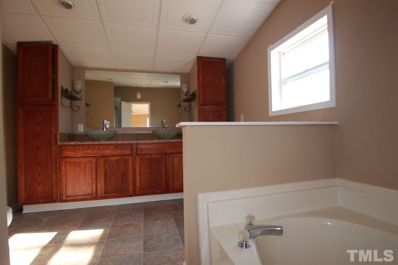290 Hal Melton Road Roxboro, NC 27574 - Photo 8 of 14 a bathroom with a bathtub and a sink