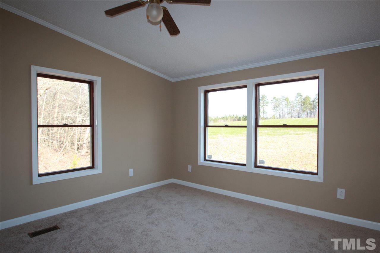 290 Hal Melton Road Roxboro, NC 27574 - Photo 10 of 14 a view of an empty room with a window