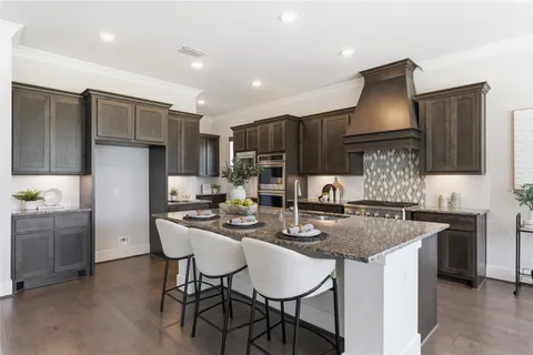 a kitchen with a table chairs and microwave