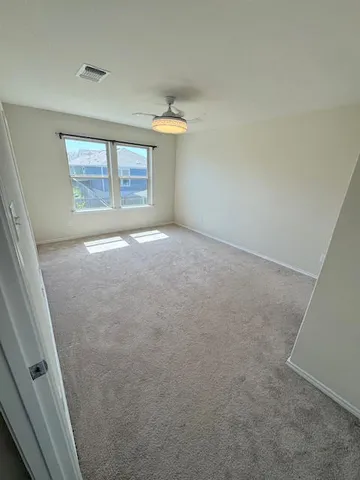 a bathroom with a granite countertop sink a toilet and a mirror
