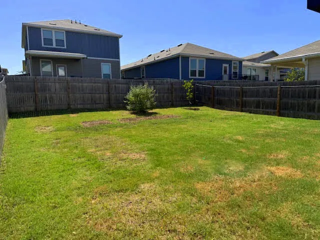 a view of a house with a backyard