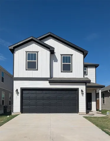 a front view of a house with garage