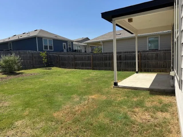 a view of an house with backyard space and balcony