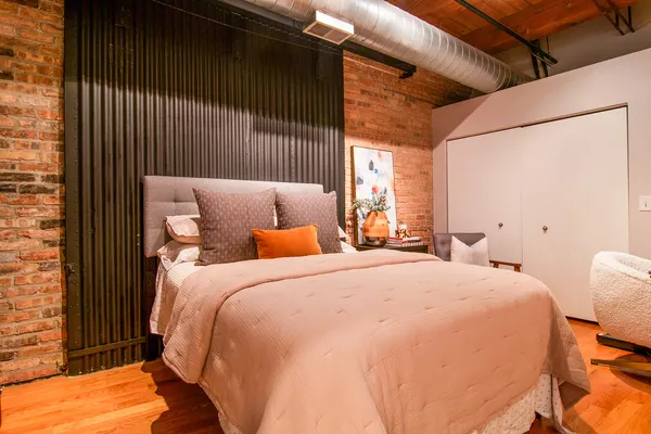 a bed sitting in a bedroom next to a window