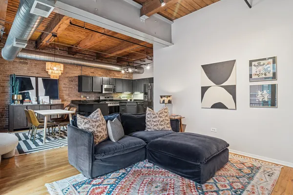 a living room with furniture and a ceiling fan