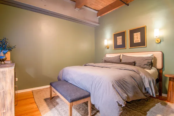 a bedroom with a bed and a night stand
