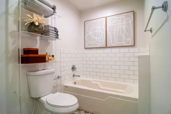 a bathroom with a toilet a sink and bathtub