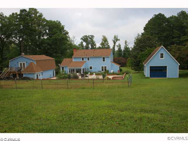 15018 Harrowgate Road Chester, VA 23831 - Photo 4 of 12 a backyard of a house with table and chairs