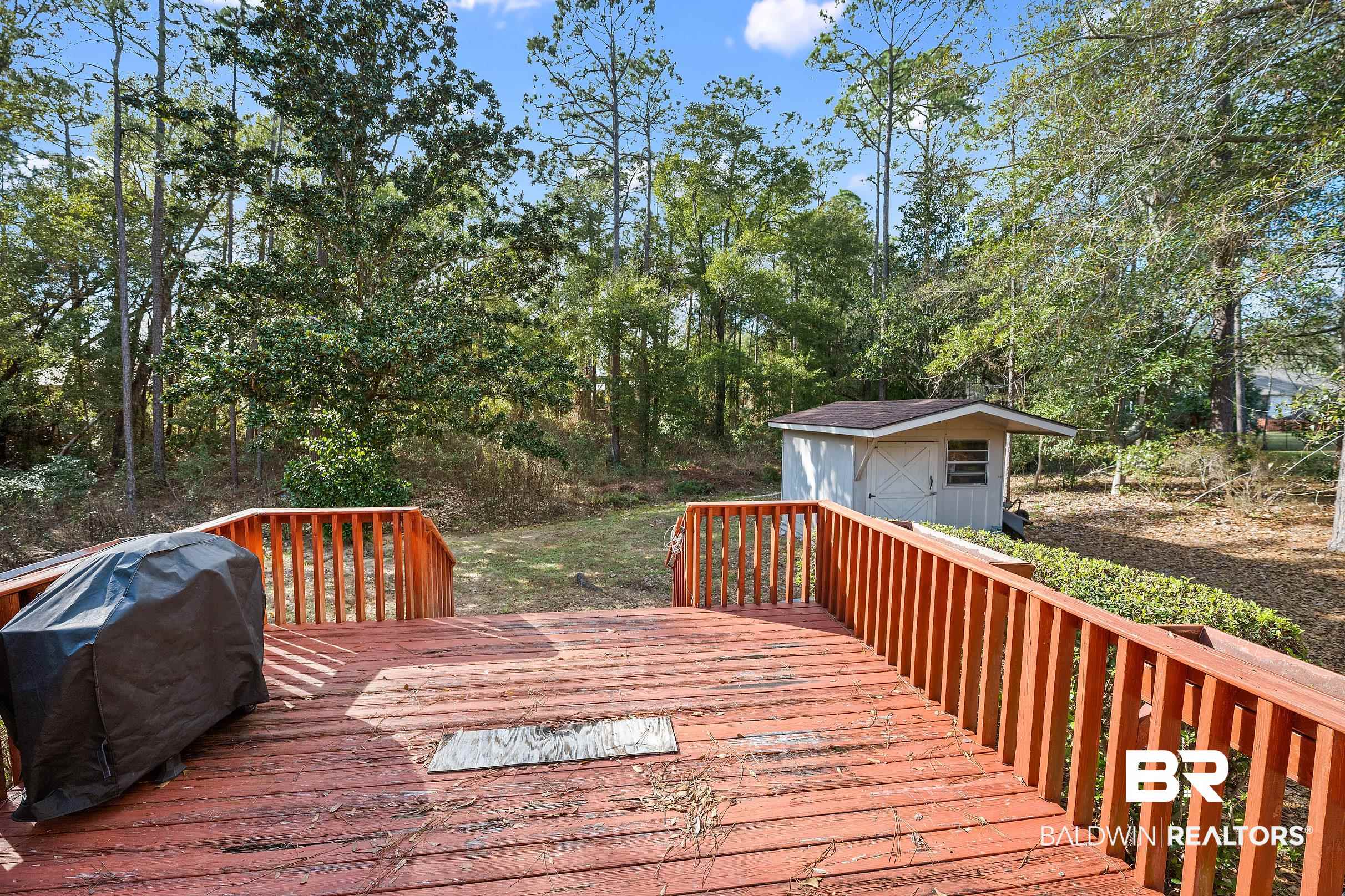 2674 Pine Ridge Drive Lillian, AL 36549 - Photo 23 of 42 Wooden terrace with grilling area and a storage shed