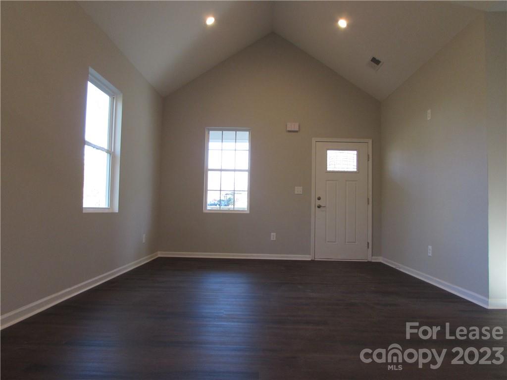 504 Messner Street, Unit 5 Salisbury, NC 28144 - Photo 2 of 11 an empty room with wooden floor and windows