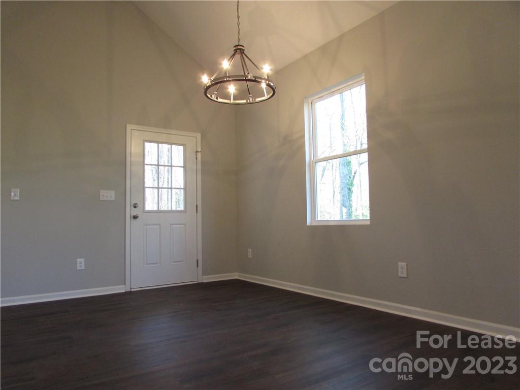 504 Messner Street, Unit 5 Salisbury, NC 28144 - Photo 3 of 11 an empty room with wooden floor chandelier and windows