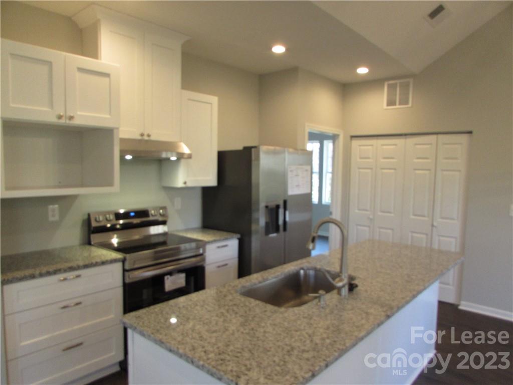 504 Messner Street, Unit 5 Salisbury, NC 28144 - Photo 4 of 11 a kitchen with a refrigerator and a sink