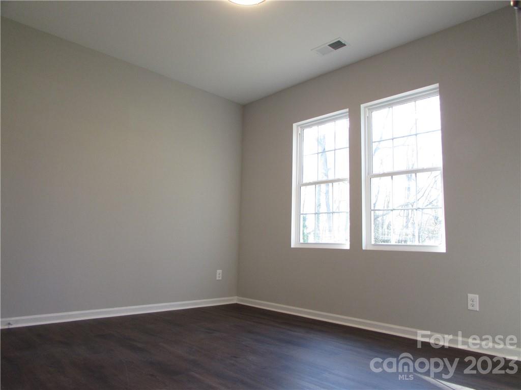 504 Messner Street, Unit 5 Salisbury, NC 28144 - Photo 6 of 11 an empty room with wooden floor and windows