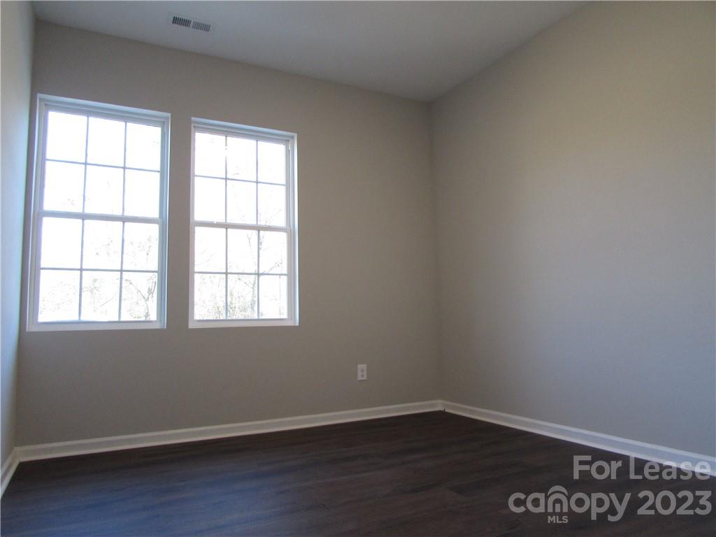 504 Messner Street, Unit 5 Salisbury, NC 28144 - Photo 8 of 11 an empty room with wooden floor and windows