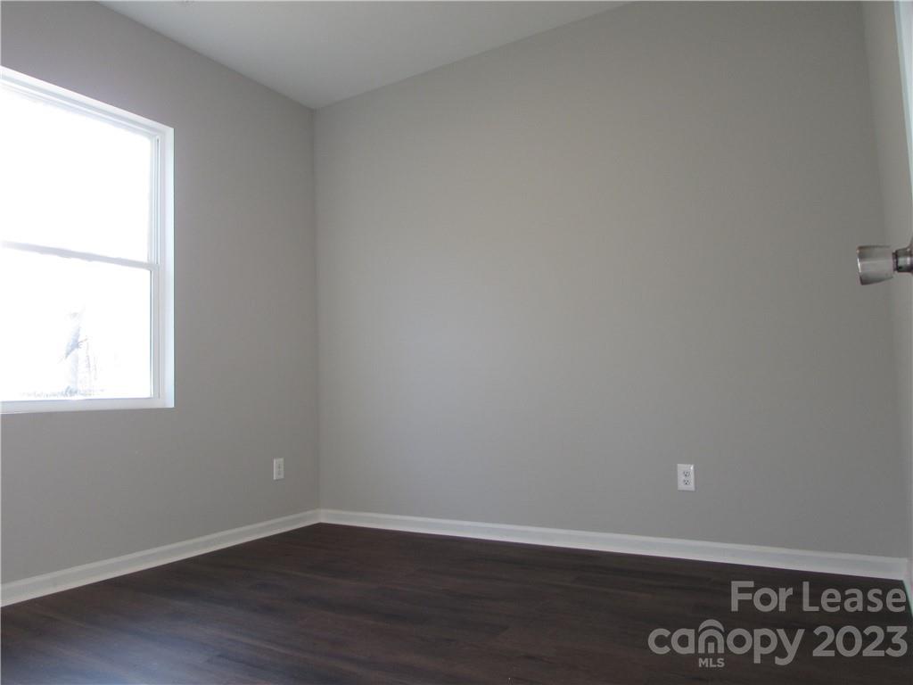 504 Messner Street, Unit 5 Salisbury, NC 28144 - Photo 9 of 11 an empty room with wooden floor and windows