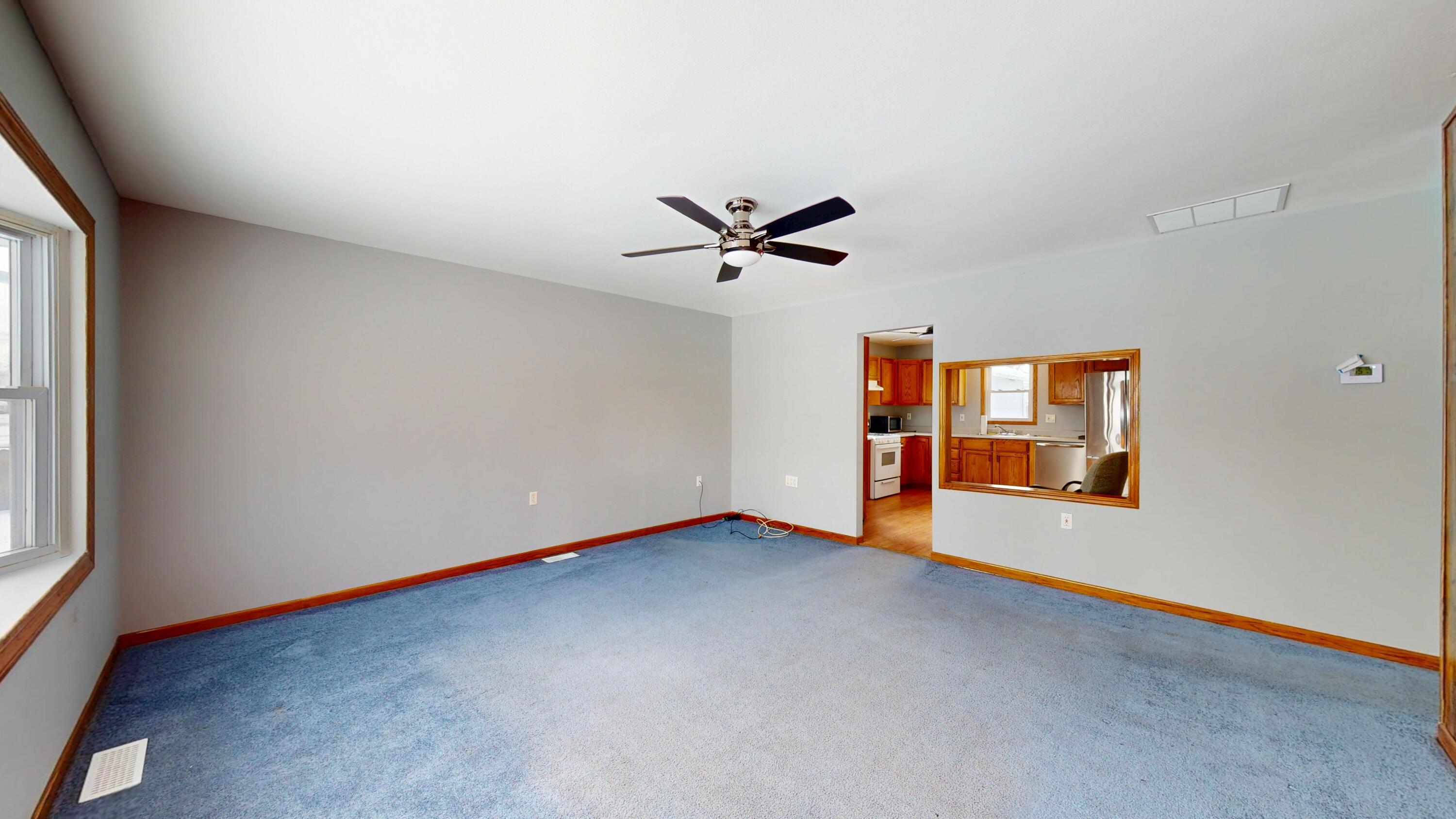 734-1 Juniper Road Valparaiso, IN 46385 - Photo 4 of 34 an empty room with windows and ceiling fan