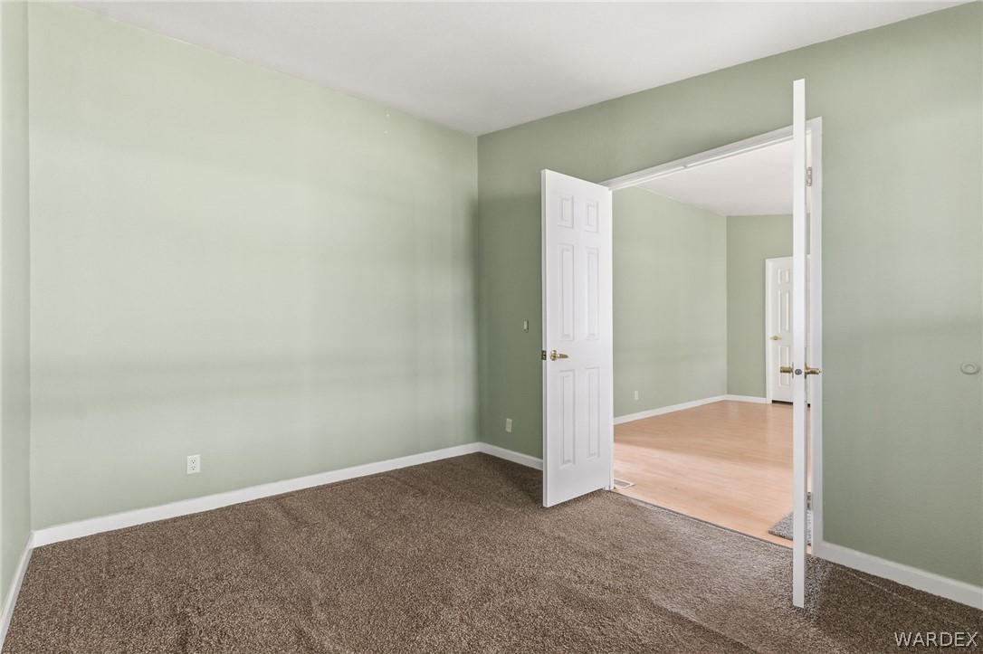 3894 North Lookout Canyon Road Kingman, AZ 86401 - Photo 21 of 64 Unfurnished bedroom featuring baseboards and carpet