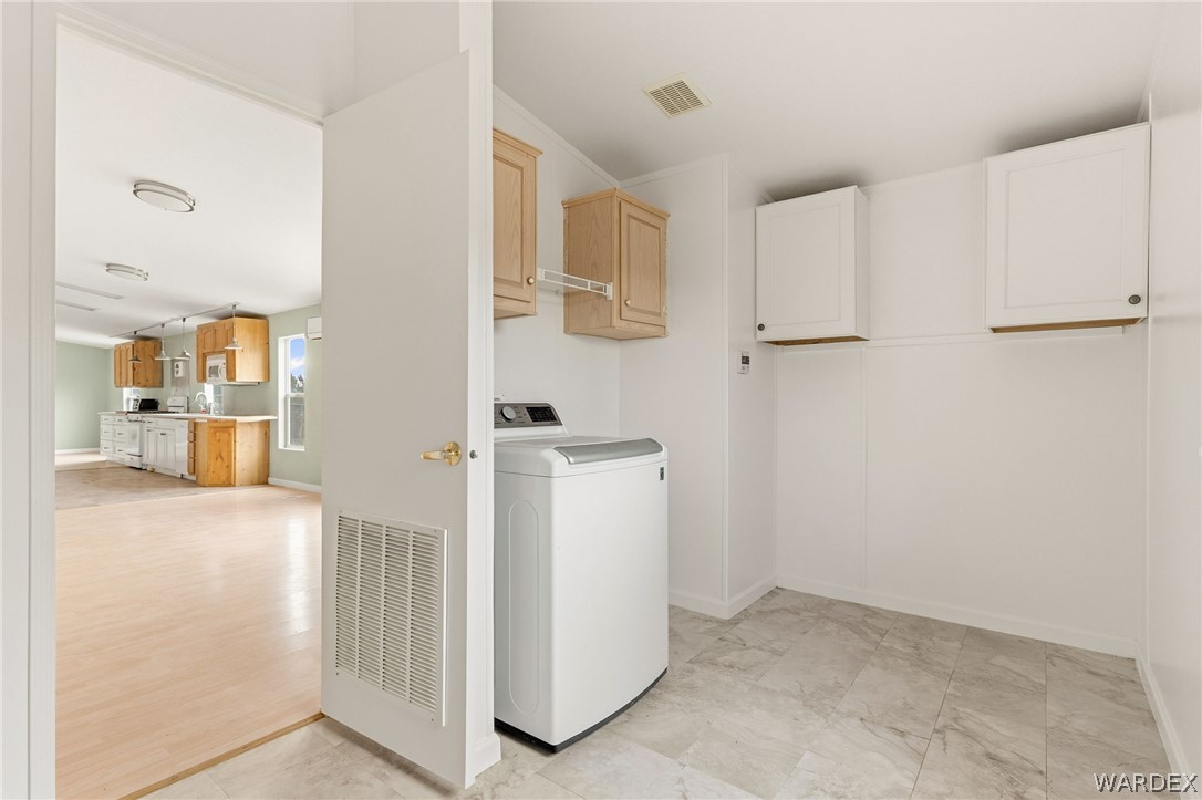 3894 North Lookout Canyon Road Kingman, AZ 86401 - Photo 22 of 64 Laundry area with washer / clothes dryer and cabinet???????????????????????????????? space