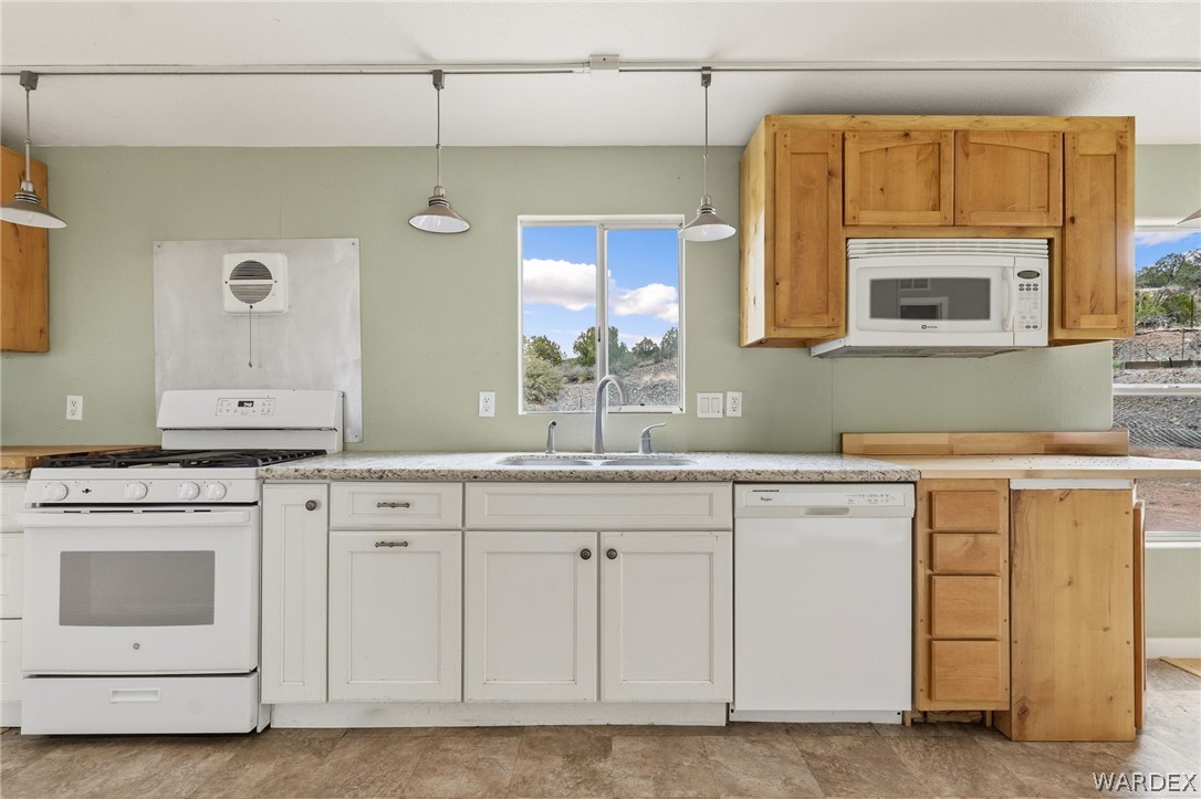 3894 North Lookout Canyon Road Kingman, AZ 86401 - Photo 23 of 64 Kitchen with white appliances, light countertops, and pendant lighting