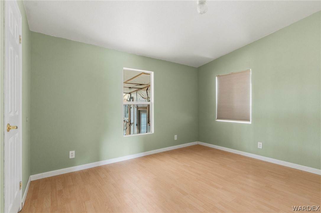 3894 North Lookout Canyon Road Kingman, AZ 86401 - Photo 25 of 64 Empty room featuring light wood-style flooring and baseboards