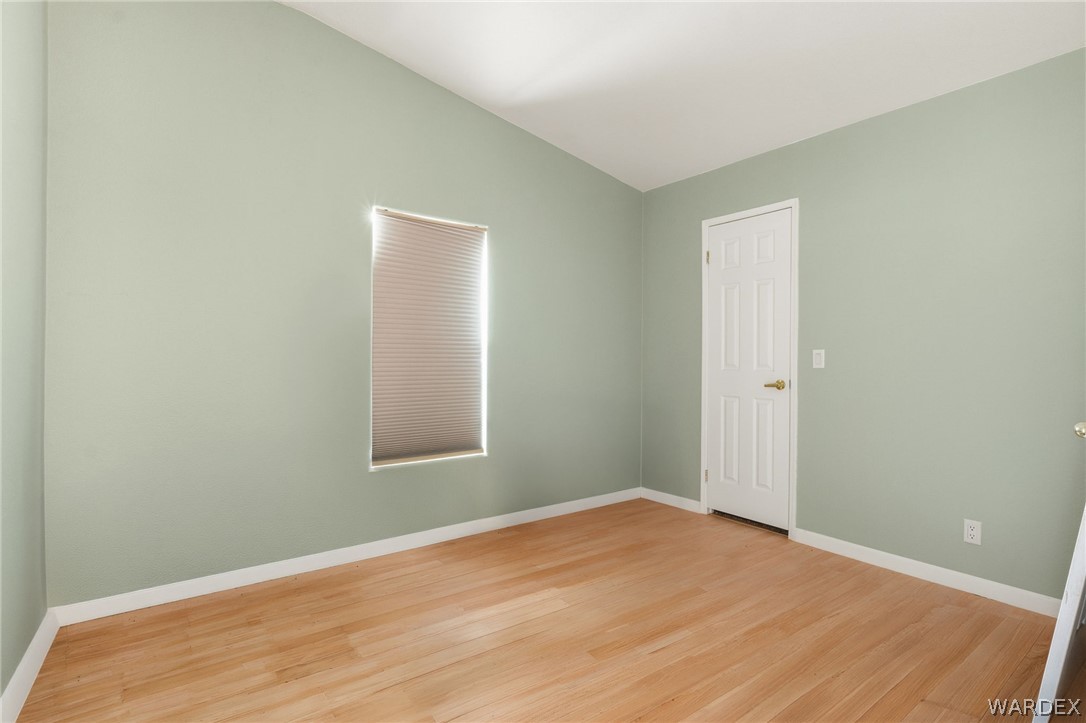 3894 North Lookout Canyon Road Kingman, AZ 86401 - Photo 27 of 64 Unfurnished room with light wood-style floors and lofted ceiling