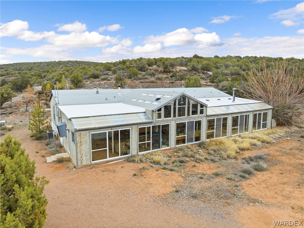 3894 North Lookout Canyon Road Kingman, AZ 86401 - Photo 3 of 64 Back of house featuring a sunroom and a forest view
