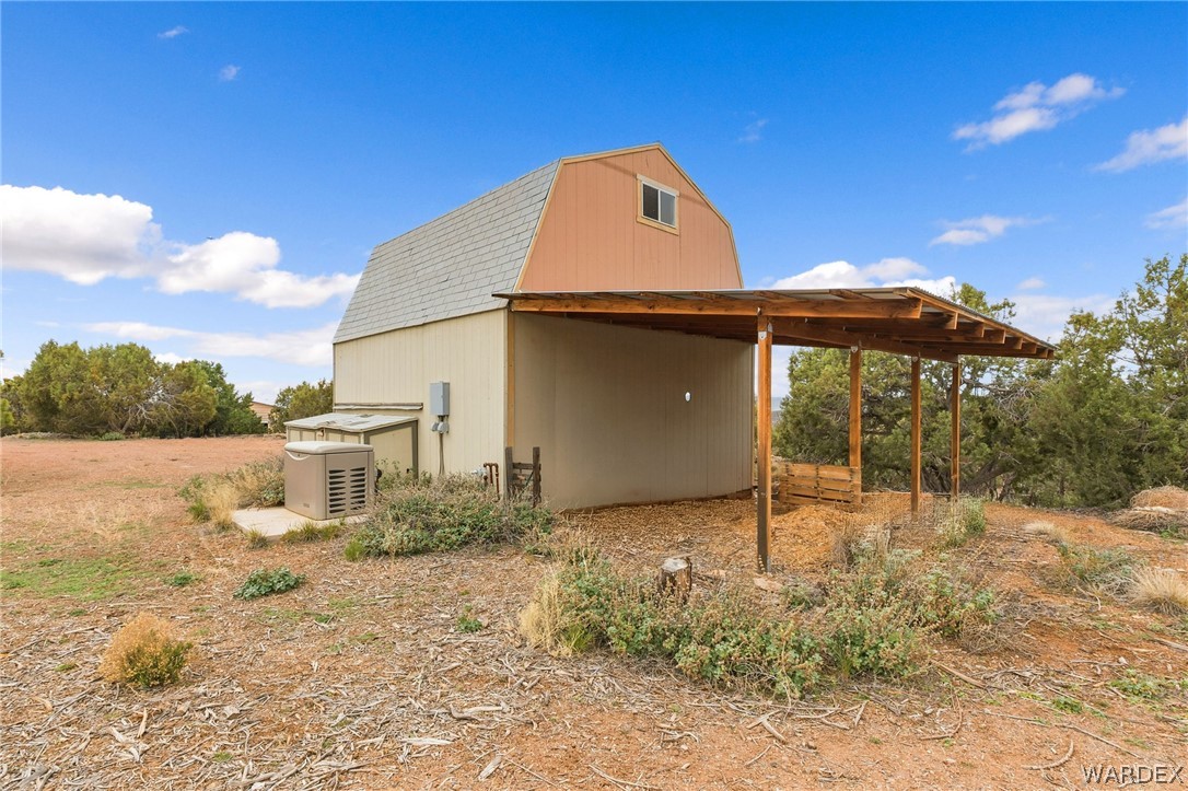 3894 North Lookout Canyon Road Kingman, AZ 86401 - Photo 38 of 64 View of side of home featuring a gambrel roof and an outdoor structure