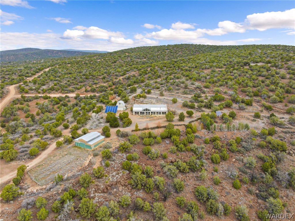 3894 North Lookout Canyon Road Kingman, AZ 86401 - Photo 49 of 64 Aerial view of sparsely populated area featuring a desert landscape and a mountain backdrop