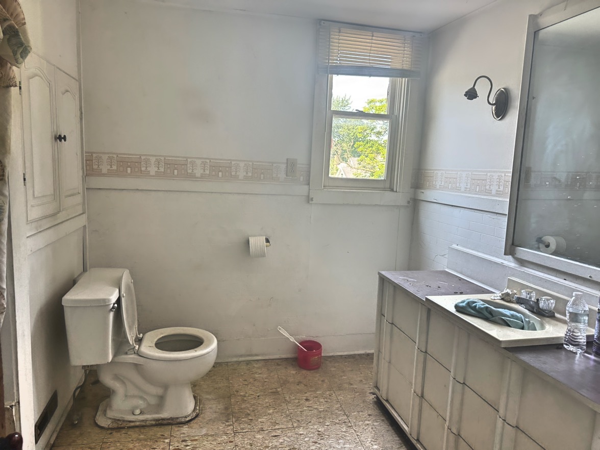 313 North 5th Street Watseka, IL 60970 - Photo 11 of 16 a bathroom with a sink toilet and window