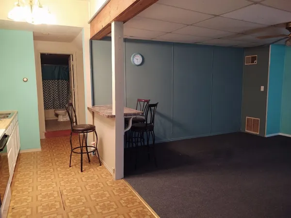 a view of a livingroom with furniture and an entrance