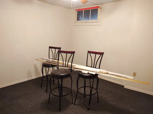 a view of a room with furniture and a table