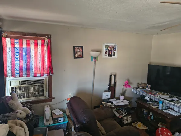 a living room with furniture a flat screen tv and a fireplace
